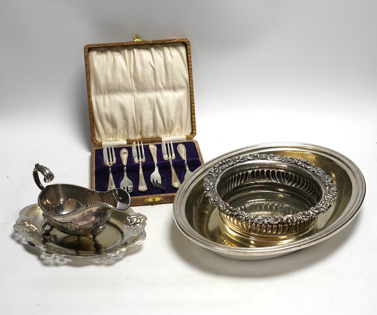 Assorted plated ware including a salver, a sauceboat and a cased set of forks